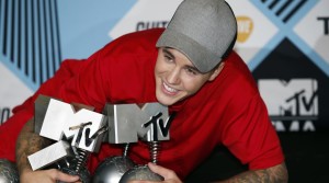 Justin Bieber poses with his awards during a photo call at the 2015 MTV European Music Awards in Milan, Italy, Sunday, Oct. 25, 2015. (AP Photo/Antonio Calanni)