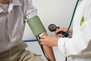 Doctor Taking Man's Blood Pressure