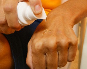 Woman Applying Gel to Back of Hand