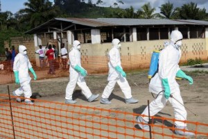 Na Liberia, trabalhadores da área de saúde isolam área onde uma mulher morreu vítima de ebola (Ahmed Jallanzo/Agência Lusa/Direitos Reservados)