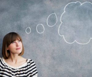 woman with thought bubble on chalk board